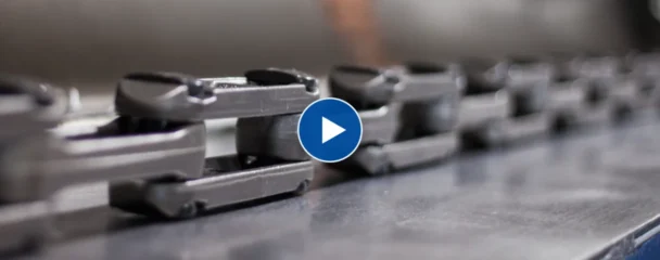 Frost Smooth Link X-type conveyor chain running along a conveyor