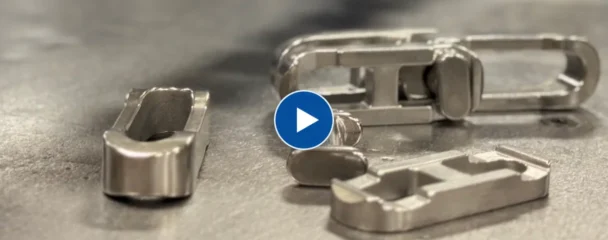 Stainless steel Smooth Link chain center links and side links on a workbench